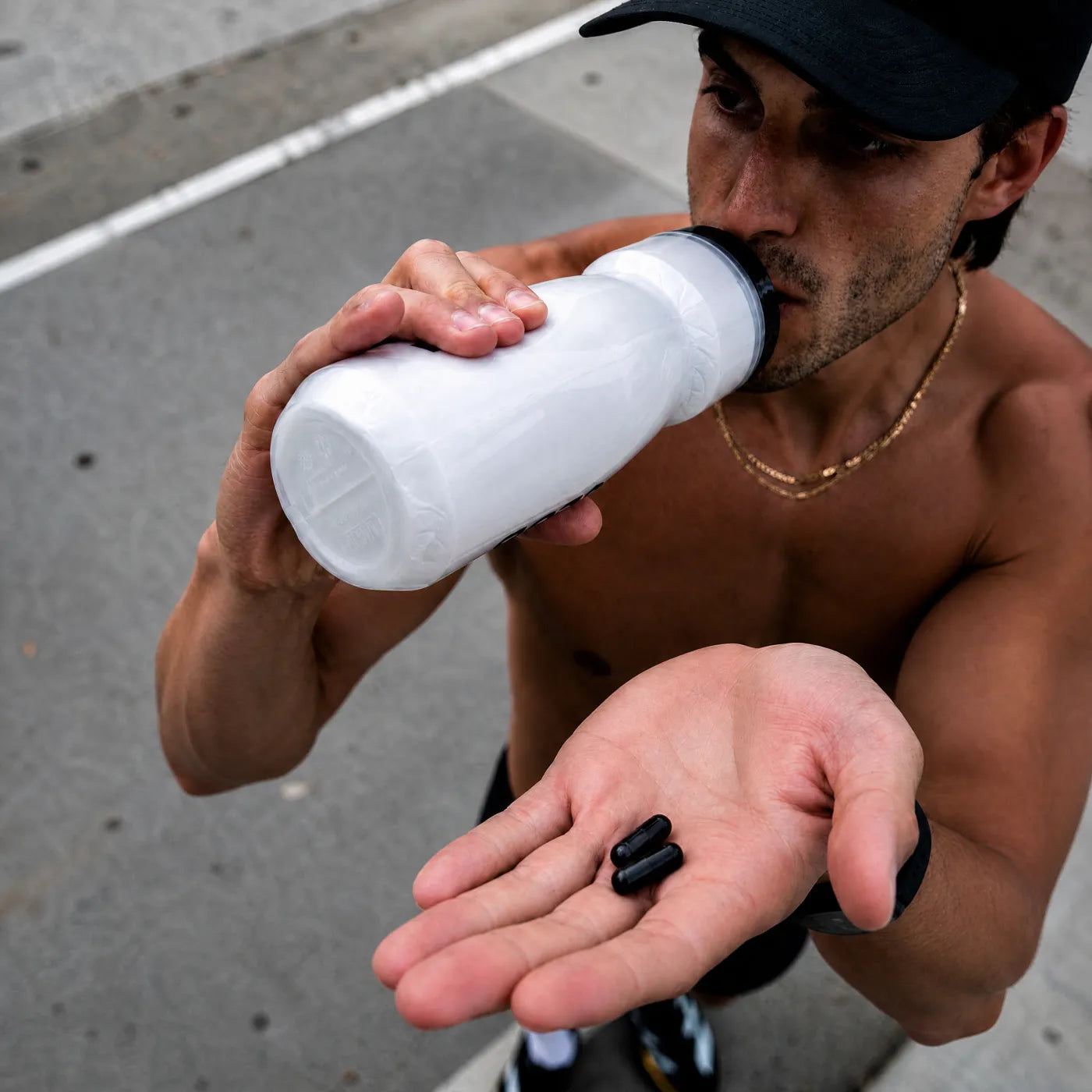 Man taking shilajit capsules with water after a run